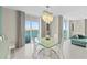 Bright dining room with water views and modern chandelier at 231 Riverside Dr # 701, Holly Hill, FL 32117