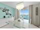 Modern dining area with water views and unique art at 231 Riverside Dr # 701, Holly Hill, FL 32117