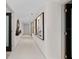 Long hallway with artwork and tiled floors at 231 Riverside Dr # 701, Holly Hill, FL 32117