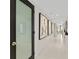 Hallway with modern frosted glass door and artwork at 231 Riverside Dr # 701, Holly Hill, FL 32117