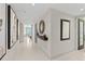 Elegant hallway with mirror and artwork at 231 Riverside Dr # 701, Holly Hill, FL 32117