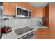 Modern kitchen with built-in appliances and sleek countertop at 231 Riverside Dr # 701, Holly Hill, FL 32117
