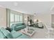 Spacious living room with light teal sofas and a large flat-screen TV at 231 Riverside Dr # 701, Holly Hill, FL 32117