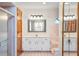 Bathroom with double vanity, large mirror, and a shower at 2332 Salem Dr, Deltona, FL 32738