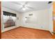 Well-lit bedroom featuring wood flooring and window with blinds at 2332 Salem Dr, Deltona, FL 32738