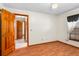 Spacious bedroom with wood flooring and access to hallway at 2332 Salem Dr, Deltona, FL 32738