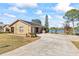 Brick home with a large driveway and lake view at 2332 Salem Dr, Deltona, FL 32738