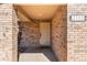 Front entrance with a light beige door and brick columns at 2332 Salem Dr, Deltona, FL 32738