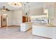 Open kitchen with island, white cabinets and tile floors at 2332 Salem Dr, Deltona, FL 32738