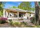 Back exterior view of the house with screened porch and landscaping at 242 Westchester Dr, Deland, FL 32724