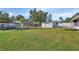 Large backyard with grassy area and storage shed at 24514 Snail Rd, Astor, FL 32102