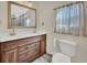 Updated bathroom with double vanity and a large mirror at 24514 Snail Rd, Astor, FL 32102