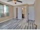 Bedroom with wood-look flooring, ceiling fan and en-suite bathroom at 24514 Snail Rd, Astor, FL 32102