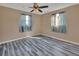 Bright bedroom with wood-look flooring and ceiling fan at 24514 Snail Rd, Astor, FL 32102