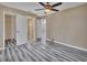 Bedroom with wood-look flooring, ceiling fan and en-suite bathroom at 24514 Snail Rd, Astor, FL 32102