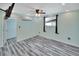 Bright bedroom with ceiling fan and wood-look floors at 24514 Snail Rd, Astor, FL 32102