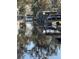 Serene waterfront view of a canal with boats and lush vegetation at 24514 Snail Rd, Astor, FL 32102