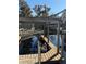 Private wooden dock with covered boat lift on a tranquil waterway at 24514 Snail Rd, Astor, FL 32102