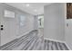 Clean and bright hallway with wood-look flooring at 24514 Snail Rd, Astor, FL 32102