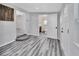 Long hallway with wood-look flooring, leading to bathroom and other rooms at 24514 Snail Rd, Astor, FL 32102