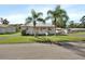 House exterior with palm trees and front porch at 24514 Snail Rd, Astor, FL 32102