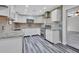 Modern kitchen with white shaker cabinets, granite counters, and stainless steel appliances at 24514 Snail Rd, Astor, FL 32102