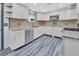 Updated kitchen featuring white cabinets, granite countertops, and stainless steel appliances at 24514 Snail Rd, Astor, FL 32102
