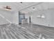 Open concept living room with hardwood floors and built-in bar at 24514 Snail Rd, Astor, FL 32102