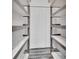 Walk-in pantry with ample shelving for storage at 24514 Snail Rd, Astor, FL 32102
