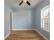 Simple bedroom with light blue walls and wood flooring at 311 Ora St, Daytona Beach, FL 32118