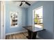 Light and airy dining area with wood floors and a view to the kitchen at 311 Ora St, Daytona Beach, FL 32118