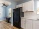 Modern kitchen with white shaker cabinets, quartz countertops, and stainless steel appliances at 311 Ora St, Daytona Beach, FL 32118