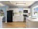 Modern kitchen with white shaker cabinets, quartz countertops, and stainless steel appliances at 311 Ora St, Daytona Beach, FL 32118