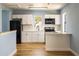 Modern kitchen with white shaker cabinets, quartz countertops, and stainless steel appliances at 311 Ora St, Daytona Beach, FL 32118