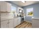 Modern kitchen with white shaker cabinets, quartz countertops, and stainless steel appliances at 311 Ora St, Daytona Beach, FL 32118