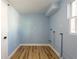 Laundry room with light blue walls and wood flooring at 311 Ora St, Daytona Beach, FL 32118