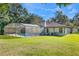 Large backyard with a screened pool and lush landscaping at 315 Huntington Dr, Deland, FL 32724