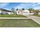 House's front exterior showcasing a landscaped yard and driveway at 3164 Wood Rose Way, Deltona, FL 32725