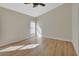 Main bedroom with wood-look floors and a large window at 3164 Wood Rose Way, Deltona, FL 32725