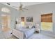 Spacious bedroom with a ceiling fan and large windows at 3190 Lori Ct, Deltona, FL 32738