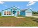 Nice curb appeal, light blue house with a two-car garage at 3190 Lori Ct, Deltona, FL 32738