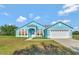 Charming light blue house with a two-car garage and spacious yard at 3190 Lori Ct, Deltona, FL 32738