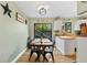 Modern kitchen with white cabinets, butcher block countertops, and a dining table at 322 Canal Rd # G40, Edgewater, FL 32132