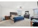 Spacious main bedroom with a king-size bed and dark dresser at 3404 Grassy Lake View Ave, Minneola, FL 34715