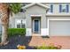Front entrance with blue door and brick walkway at 3404 Grassy Lake View Ave, Minneola, FL 34715