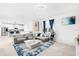 Open concept living room with kitchen view and sectional sofa at 3404 Grassy Lake View Ave, Minneola, FL 34715