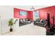 Cozy loft area with two leather sofas and a red accent wall at 3404 Grassy Lake View Ave, Minneola, FL 34715