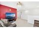 Bright loft space with large TV, comfortable seating, and a view of the home's interior at 3404 Grassy Lake View Ave, Minneola, FL 34715