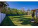 Large backyard with grassy lawn and a white fence at 3454 Country Walk Dr, Port Orange, FL 32129