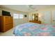 Bright bedroom with a dresser, TV, and floral bedding at 3454 Country Walk Dr, Port Orange, FL 32129